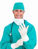 Charismatic surgeon wearing surgical gloves