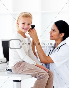 Concentrated female doctor checking her patient\'s ears 
