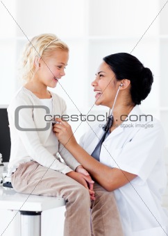 Attractive female doctor checking her patient's ears in a medical practice
