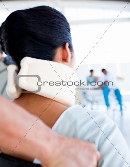 Close-up of a woman with a neckbrace sitting on wheelchair