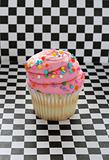 shot of a cupcake on checkered background vertical