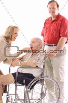 shot of a woman feeding elderly man in wheelchair