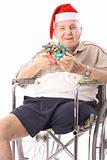 shot of an eldery man in wheelchair celebrating christmas vertical