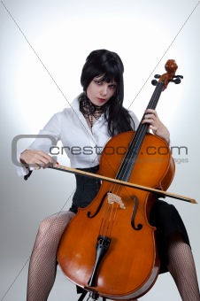Young woman playing cello 