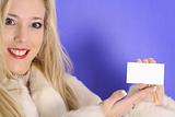 shot of a blonde holding blank business card