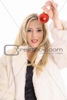 shot of a Gorgeous blonde in fur holding an christmas ornament