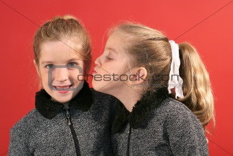 shot of a sister giving a kiss
