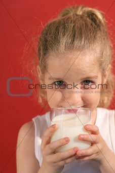 shot of a happy little girl drinking milk