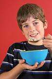 shot of a boy eating cereal vertical