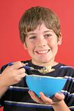 shot of young boy eating cereal vertical