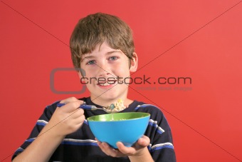shot of a young boy eating cereal