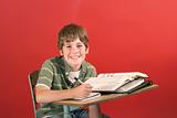 shot of a kid smiling at desk
