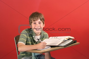 shot of a kid smiling at desk