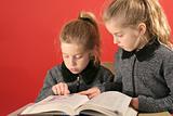 shot of Two little girls studying together