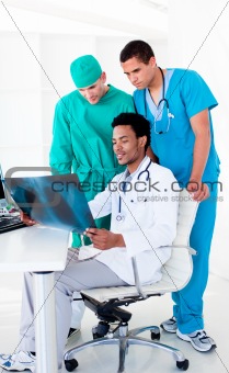 Serious male doctors looking at X-Ray