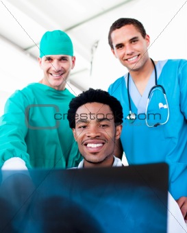Hopeful male doctors looking at X-Ray