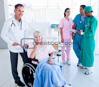 Positive medical team taking care of a senior woman