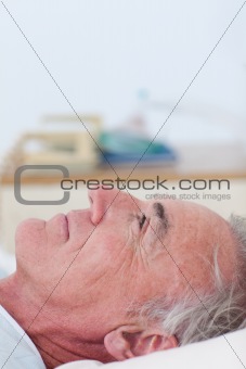 Senior patient lying on a hospital bed 