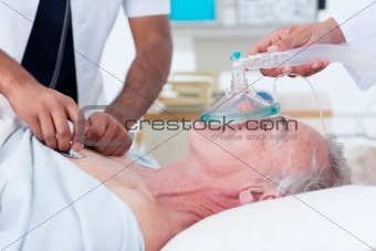 Doctors resuscitating a senior patient 