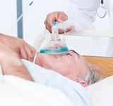 Senior patient receiving oxygen mask 