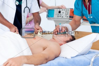 Concentrated medical team resuscitating a patient