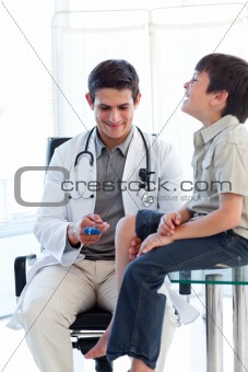 Confident male doctor checking a patient's reflex 