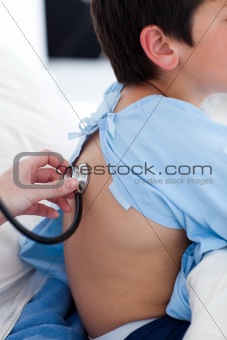 A doctor checking a child's respiratory rate 