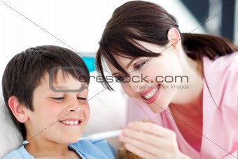 Smiling nurse and his patient looking at a thermometer 