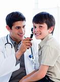 Charming doctor examining little boy's ears