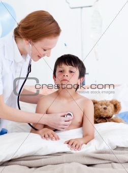 Attentive doctor examining a little boy