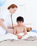 Beautiful doctor examining a little boy