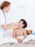 Female doctor examining a little boy
