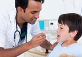 Attractive doctor giving medicine to a little boy
