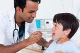 Young doctor giving medicine to a little boy