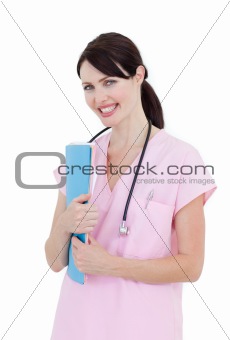 Sparkling female doctor holding patient's folder 