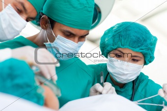 Multi-ethnic surgeons during a surgery