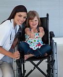 Portrait of a little girl on a wheelchair with her doctor 