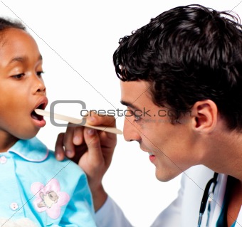 Smiling doctor checking little girl's throat 