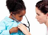 Cute little girl and her doctor playing with a stethoscope 