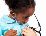 Little girl playing with a stethoscope at a medical check-up 