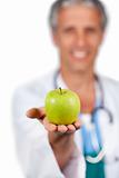 Smiling doctor presenting a green apple