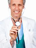Attractive doctor presenting his stethoscope 
