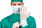Charismatic surgeon wearing surgical gloves 