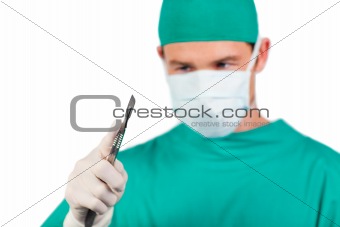 Self-assured surgeon holding a scalpel 
