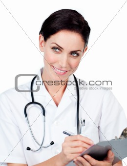 Charming doctor writing on a clipboard 