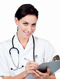 Smiling female doctor writing on a clipboard