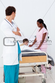 Pediatrician and nurse attending to a child in the hospital