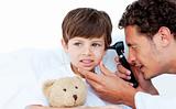 Concentrated doctor examining patient's ears