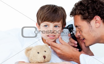 Concentrated doctor examining patient's ears