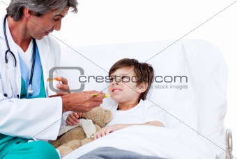 Cute little boy taking cough medicine 